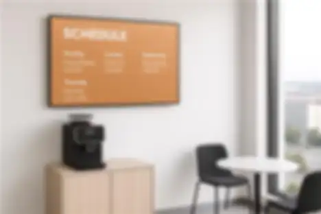 Office screen displays calendar and team events in an open workspace